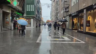Ciudadanos por Santa Clara con paraguas. Lluvia.