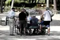 Varios pensionistas juegan al dominó en un parque. Archivo.